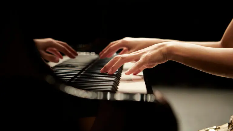 hands of a person playing piano