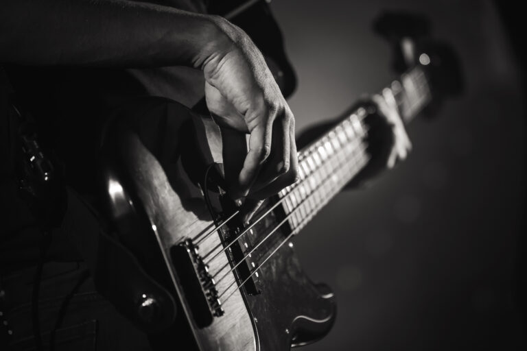 Electric bass guitar player hands, live music