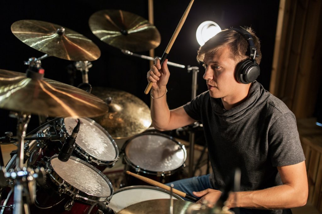 male-musician-playing-drums-and-cymbals-at-concert