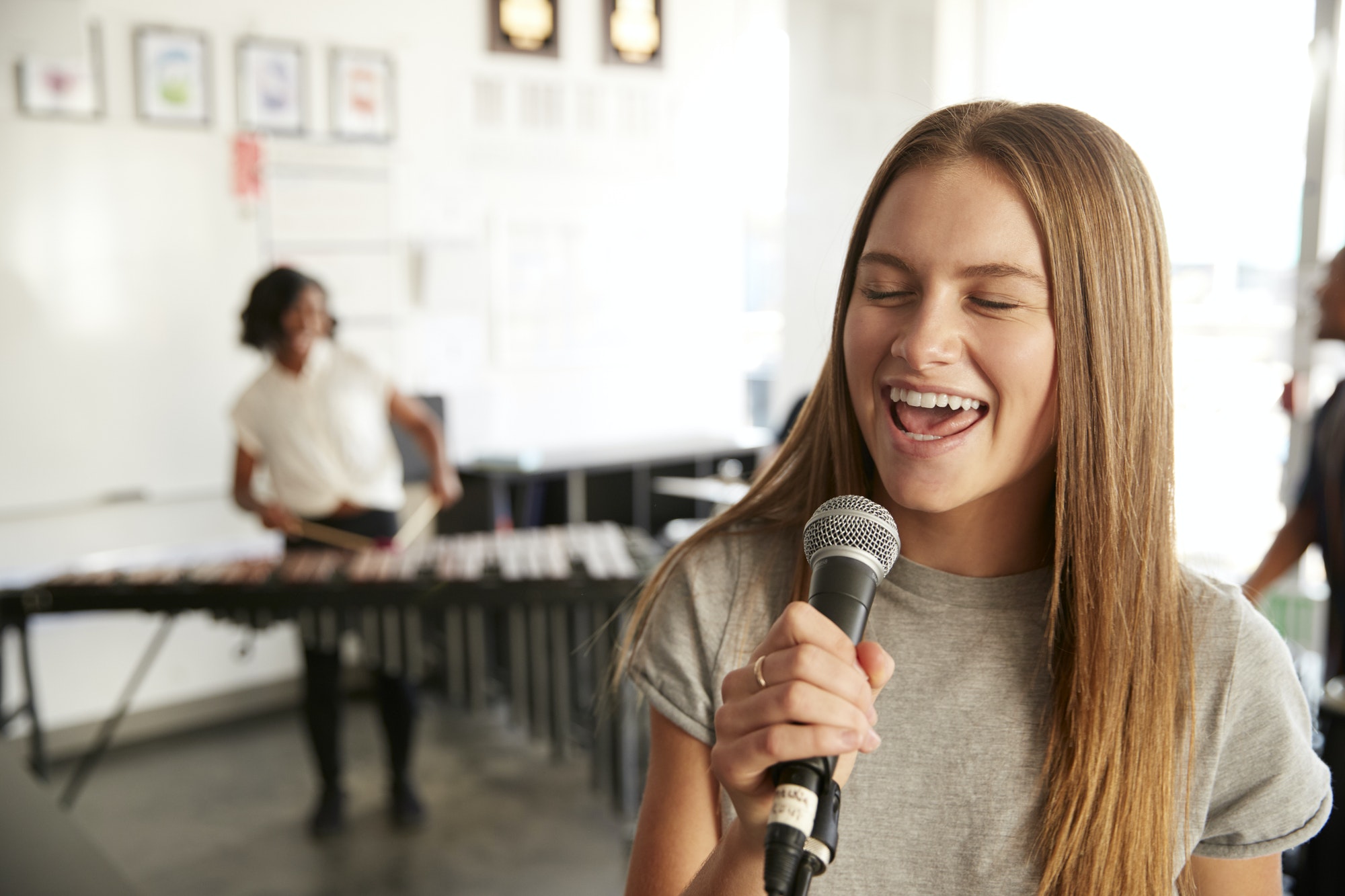 students-at-performing-arts-school-playing-in-band-at-rehearsal